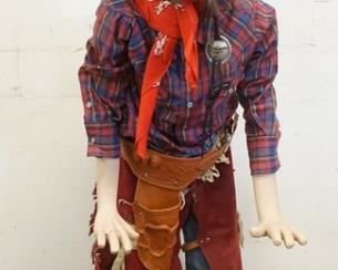 1050	BOY MANNEQUIN CLOTHED IN LEVIS JEANS, CHAPS & HOLSTER, PIERRE CARDIN SHIRT, BANDANNA, WIG & A FEATHERED HAT W/ A VINTAGE COCA COLA RODEO PIN. MANNEQUIN MAY SUFFER SOME LOSSES TO BODY/FACE 
