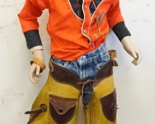 1066	YOUNG BOY MANNEQUIN CLOTHED IN VINTAGE LEVIS JEANS, CHAPS, BOLLO TIE W/ SADDLE CLIP, VINTAGE SEARS WESTERN SHIRT & A NEW JERSEY SHERIFF PIN. APP. 48 IN TALL. MANNEQUIN MAY SUFFER LOSSES TO FACE/BODY
