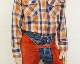 1106	BOY MANNEQUIN CLOTHED IN VINTAGE LEVIS SELVEDGE JEANS W/ BIG E, CHAPS, BANDANNA, VINTAGE LEVIS SHIRT, & COWBOY HAT. APP 61 IN TALL. MANNEQUIN MAY SUFFER LOSSES TO BODY/FACE
