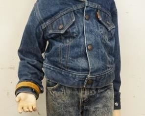 1110	YOUNG BOY MANNEQUIN CLOTHED IN VINTAGE ORANGE TAB LEVIS JEANS, A BELT W/ A GUN BELT BUCKLE, A LEVIS DENIM JACKET, WESTERN SHIRT, & A BOOT HILL COWBOY HAT. APP. 39 IN TALL. MANNEQUIN MAY SUFFER LOSSES TO BODY/FACE
