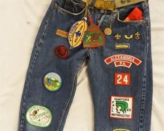1130	LOT OF THREE PAIRS OF VINTAGE LEVIS JEANS ALL HAVE BIG E. TWO OF THE PAIRS HAVE BLUE/BLACK TABS & ARE YOUTH SIZES- ONE SIZE IS UNKNOWN THE OTHER IS SIZE 10. & A PAIR OF RED TAB BIG E SELVEDGE LEVIS JEANS WITH BOY SCOUTS PINS & PATCHES, THE PANTS ALSO COME WITH A BELT & BUCKLE W/ THE BOY SCOUTS INSIGNIA, A BANDANNA WHICH READS *PHILMONT RANCH CIMARRON N. MEXICO*, THE PATCH SEWN ONTO THE BACK IS ALSO BOY SCOUTS RELATED. THE REVERSE OF THE TOP BOTTON ON THE JEANS IS STAMPED W/ THE NUMBER 8, WAIST MEASURES APP. 25 IN 
