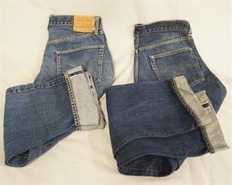 1135	LOT OF TWO PAIRS OF LEVIS SELVEDGE JEANS W/ BIG E. ONE PAIR WAIST MEASURES APP. 31 IN & HAS A SMALL HOLE ON THE UPPER BACK. THE REVERSE OF THE TOP BUTTON IS STAMPED 6. THE OTHER PAIR THE WAIST MEASURES APP. 34 IN & THE REVERSE OF THE TOP BUTTON IS STAMPED K. VARYING DEGREES OF WEAR 
