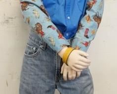 1143	BOY MANNEQUIN CLOTHED IN LEVIS JEANS, VINTAGE WESTERN SHIRT, & COWBOY HAT. APP. 53 IN TALL. MANNEQUIN MAY SUFFER LOSSES TO BODY/FACE
