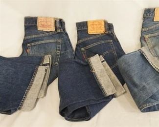 1169	LOT OF THREE PAIRS OF VINTAGE LEVIS SELVEDGE JEANS. ONE THE SIZE IS UNKNOWN WAIST MEASURES APP. 26 IN THE REVERSE OF THE TOP BUTTON IS STAMPED 8. THE OTHERS ARE SIZES; 30 X 31 ( REVERSE OF TOP BUTTON IS STAMPED 6) & 27 X 27 (REVERSE OF TOP BUTTON IS STAMPED W) VARYING DEGREES OF WEAR 
