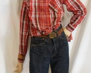 1185	BOY MANNEQUIN CLOTHED IN VINTAGE LEVIS SELVEDGE JEANS W/ BIG E, BELT W/ LEVIS BELT BUCKLE, LEVIS SHIRT, BANDANNA & A COWBOY HAT. APP. 60 IN TALL. MANNEQUIN MAY SUFFER LOSSES TO BODY/FACE
