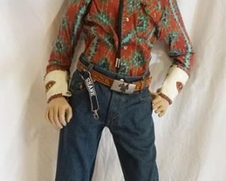 1186	BOY MANNEQUIN CLOTHED IN LEVIS JEANS, COWBOY BOOTS, BELT W/ BELT BUCKLE, VINTAGE STIR-UPS WESTER SHIRT, BOLLO TIE W/ TIE CLIP, ARM BANDS, & A TRAIL BOSS COWBOY HAT. APP. 52 IN TALL. MANNEQUIN MAY SUFFER LOSSES TO BODY/FACE
