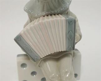 1040	LLADRO YOUNG BOY ON DOMINO PLAYING CONCERTINA, 8 IN HIGH
