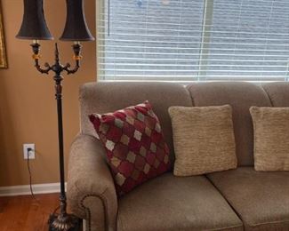 Lamp and three cushion sofa.
