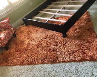 a better view of the shag rug and the frame of the bassett bed