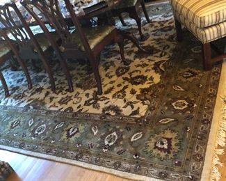 Rug under dining table and glimpse of the drexel dining table with ten chairs