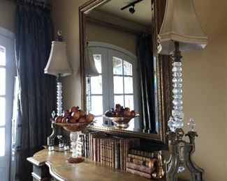 great mirror over the fabulous painted cabinet and grand scale lamps