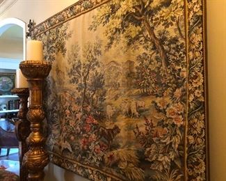 closer photo of the tapestry and antique hand carved candlesticks