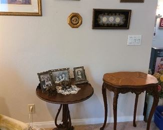 Antique tables and framed art.