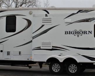 2014  Bighorn 3685RL with low mileage in excellent condition.
This rear living Bighorn fifth wheel has got you covered with everything needed to enjoy time away from home. Model 3685RL features triple slides for added interior space, a convenient kitchen island, and a spacious master suite with king size bed!
The combined kitchen and living room feature a wide open space due to dual opposing slides. There is a dining table with two chairs,  comfortable sofa and swivel recliners. 
Kitchen appliances and all the essentials to make this your home away from home.  Television and desk space too.
Along the rear wall you will find a comfortable hide-a-bed sofa to provide day-time seating and extra sleeping space at night. There is an overhead storage cabinet with glass door inserts, plus end tables on both sides of the hide-a-bed.
There is a three burner range with microwave above, refrigerator, pantry, and convenient kitchen island with double sink.
Head up the steps to a side aisle bathroom