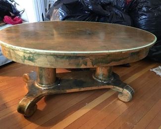 Gold painted oval shaped wood coffee table , 43”