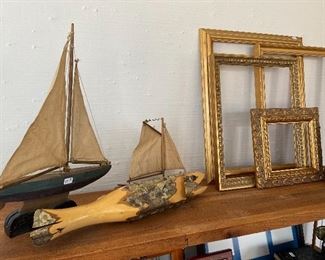Carved fish from branch, sailboats and frames.