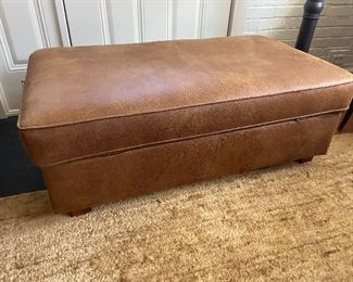 Large leather covered ottoman with storage.