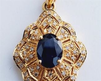 18k gold pendant with sapphire and 62 faceted diamonds.