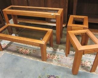 FOUR PIECE OAK LIVING ROOM TABLE SET: SOFA TABLE, COFFEE TABLE AND TWO SIDE TABLES. ALL TABLES HAVE GLASS.