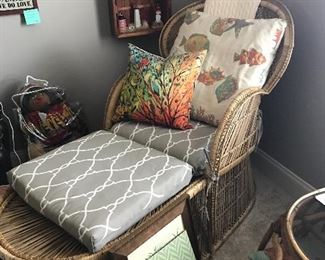 Nice wicker chair with foot rest.  Notice in background - a collection of vintage Lefton Lighthouses in a cool boat display case.  House is filled with beautiful decorative pillows as well. 