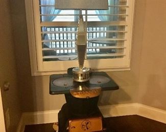 Vintage cast iron heater cleaned up and painted with gold trim - makes for a beautiful accent piece. Stunning streamlined mirrored lamp makes for an interesting juxtaposition of design.