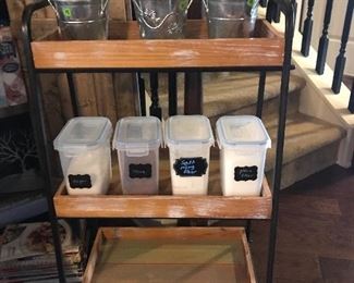 Three tiers of wood shelving that rolls.