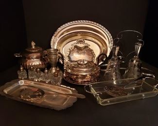 https://ctbids.com/#!/description/share/719464 WM Rogers Silver Plated and Glass Tableware. Silver plated bowls, platters, cranberry serving sets, salt shakers, bells and candle holder. Largest measures 12"L x 9"H and smallest measures 2"H x 1"L.


