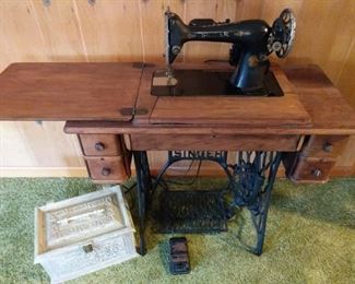 https://ctbids.com/#!/description/share/719389 Vintage Singer sewing machine with cabinet. Machine's light and engine work as seen in video, but the engine is not turning the wheel so might need a tuneup. The machine and table are in excellent condition. The sewing box is made of plastic, but in great condition.

Machine: 34"x16"x30"