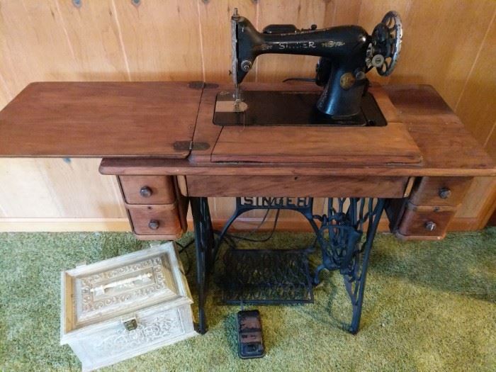 https://ctbids.com/#!/description/share/719389 Vintage Singer sewing machine with cabinet. Machine's light and engine work as seen in video, but the engine is not turning the wheel so might need a tuneup. The machine and table are in excellent condition. The sewing box is made of plastic, but in great condition.

Machine: 34"x16"x30"
