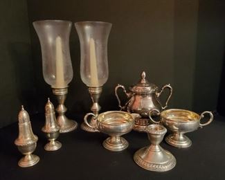 https://ctbids.com/#!/description/share/719338 Collection of sterling silver and silverplated items. 2 Poole glass candle candleholders with weighted sterling bases, sterling silver salt and pepper shakers sterling 159 (49 grams), weighted sterling candleholder, 3 piece Revere Silversmiths tea set (larger lidded piece is silverplated, other 2 pieces are weighted sterling). Combined weight of weighted sterling pieces is 1 pound 12.2 ounces. Weight of sterling salt and pepper shakers is 49 grams.

