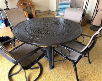 Cast aluminum patio table + chairs -  2 swivel rockers & 2 side chairs and winter covers