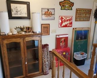Beer signs.  Nice oak glass front bookcase.