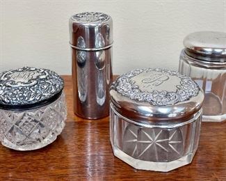 Item 149:     (A and B are sold!)                                                                                            
c. Sterling, Monogrammed Vanity Jar - 2": $55                              d. Sterling Top, Glass Bottom Vanity Jar - 2.5": $28             a. Antique Cut Glass Monogrammed Sterling Repousse Vanity - 2": $68  SOLD!!!                                                                                                b. Tall, antique, monogrammed sterling container - 3.25": $50    SOLD!!!    