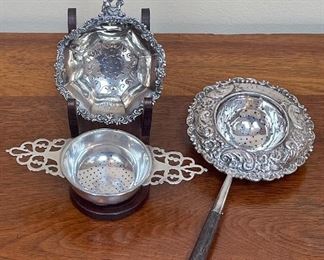 Item 146:  Sterling Silver Tea Strainers:                                                             a. Top Left: $95  SOLD                                                                                        b. Bottom Left (double handle) $40   SOLD                                        c. Right with long handle: $65 SOLD!!!
