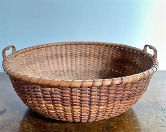 Item 312:  William Appleton (1851-1918) Round Nantucket Sewing Basket circa 1890, two heart shaped handles, multiple interior concentric circles in cherry base - 8.25" x 3.75": $845
