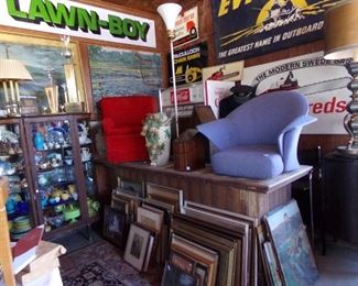 STACKS OF ORIGINAL VINTAGE ARTWORK FROM SEVERAL WEST MICHIGAN ESTATES. HERMAN MILLER PROTYPE CHAIR. SORRY, VINTAGE SIGNAGE IS PART OF THE ACT.