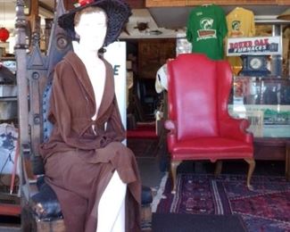SEATED MANNEQUIN FROM THE 1920/30S. LEATHER WING BACK CHAIR WITH BRASS TACKS.