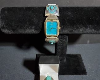 https://ctbids.com/#!/description/share/721055 Beautiful turquoise and sterling silver Arenix watch. Speidel band is stainless steel, the 2 turquoise parts of watch are sterling silver and measure 1.75" each. Turquoise tested with acetone and no color transfer noted. Total weight 1.8oz. Turquoise and silver ring is a very large size ring, possibly a 10. Robin egg stone is close to .75" and weighs .03 oz