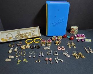 https://ctbids.com/#!/description/share/721065 Nice large assortment of earrings. Includes dangle, clip on and stud backing. Blue plastic Jewelry Keeper holds many more pairs of earrings. 5x3x7" and finally there is a small box of mismatched earrings. These have not been checked thoroughly. There may be precious metals or stones included.