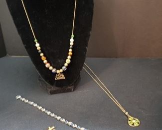 https://ctbids.com/#!/description/share/721132 Beautiful 20" Speidel 14k gold necklace with colored beads and a 14k gold Live, Laugh, Love charm. The small gold pendant, horse earring, and hoop earring with heart and cross are all 14k gold. The 18" necklace with peridot colored stones is beautiful but the authenticity of the stones and metal are unknown. The 8" blue topaz bracelet with faceted stones was found in the same drawer as a box labeled blue topaz. We are not certain that it came in that box.