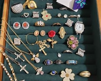 https://ctbids.com/#!/description/share/721134 Assortment of jewelry. Most rings are a size 7. The Avon and Sarah Coventry rings are adjustable. A few are smaller or larger. Sterling silver ring with 2 ruby baguettes has 2 accent stones that may be diamonds. At least 2 rings are sterling. Authenticity of all other metals and stones unknown. Ten Commandments watch needs to be restrung (incomplete). Jewelry box for sale in another lot.