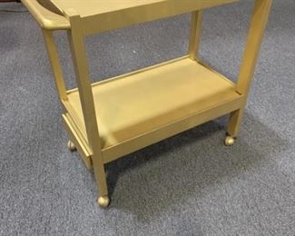 Rolling serving cart painted gold with one drawer.