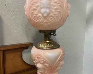 Peachy pink cherub hurricane lamp. Top and bottom light, one nose is chipped.