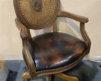 Wood and rattan rolling desk chair.