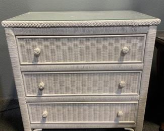 White three drawer wicker nightstand or side table.