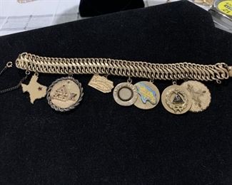 12 karat GF charm bracelet with seven charms. Charms 12 k GF except the Pennsylvania is 14 K. Initials or dates on the back.