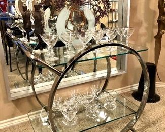 Cantoni modern chrome and glass bar cart with push handle.