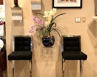 Pair of Cantoni chrome and black bar stools with foot rests.  Another purple and black art glass flower pot, modern sculptures and art.