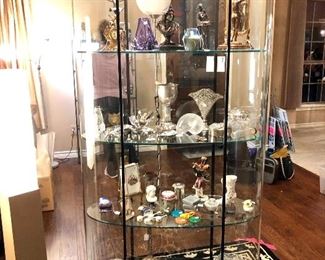 The fantastic oval lighted showcase full of beautiful things.  This one doesn't have to go against the wall as it is truly a 360 degree view!