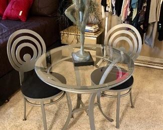 Cantoni glass and metal bistro table and 2 chairs.  Fantastic!  Note the ballerina (I think) statue on top. Nice long lines.